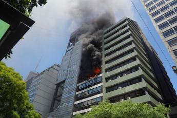 Buenos Aires, Argentina.- In the photos taken on December 12, 2023, firefighters fight the flames of a fire that broke out on two floors of a building adjacent to the headquarters of the Ministry of Labor, Employment and Social Security, in Buenos Aires. A woman died and more than eighty people had to be evacuated and treated by SAME due to the fierce fire. The first data from the investigation showed that the building did not have a gas connection, so the start of the fire could have been due to an electrical fault.