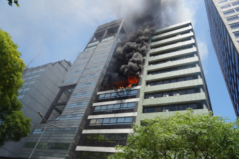 Buenos Aires, Argentina.- In the photos taken on December 12, 2023, firefighters fight the flames of a fire that broke out on two floors of a building adjacent to the headquarters of the Ministry of Labor, Employment and Social Security, in Buenos Aires. A woman died and more than eighty people had to be evacuated and treated by SAME due to the fierce fire. The first data from the investigation showed that the building did not have a gas connection, so the start of the fire could have been due to an electrical fault.