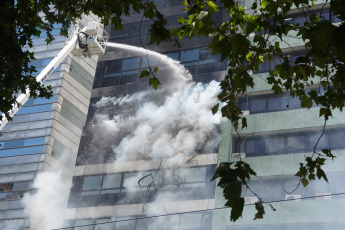 Buenos Aires, Argentina.- In the photos taken on December 12, 2023, firefighters fight the flames of a fire that broke out on two floors of a building adjacent to the headquarters of the Ministry of Labor, Employment and Social Security, in Buenos Aires. A woman died and more than eighty people had to be evacuated and treated by SAME due to the fierce fire. The first data from the investigation showed that the building did not have a gas connection, so the start of the fire could have been due to an electrical fault.