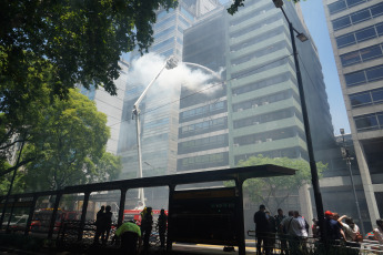 Buenos Aires, Argentina.- In the photos taken on December 12, 2023, firefighters fight the flames of a fire that broke out on two floors of a building adjacent to the headquarters of the Ministry of Labor, Employment and Social Security, in Buenos Aires. A woman died and more than eighty people had to be evacuated and treated by SAME due to the fierce fire. The first data from the investigation showed that the building did not have a gas connection, so the start of the fire could have been due to an electrical fault.