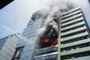 Buenos Aires, Argentina.- In the photos taken on December 12, 2023, firefighters fight the flames of a fire that broke out on two floors of a building adjacent to the headquarters of the Ministry of Labor, Employment and Social Security, in Buenos Aires. A woman died and more than eighty people had to be evacuated and treated by SAME due to the fierce fire. The first data from the investigation showed that the building did not have a gas connection, so the start of the fire could have been due to an electrical fault.